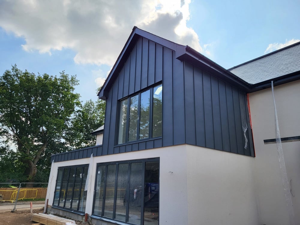 Roofing and cladding contractors make exterior of house stand out a mile with Standing Seam detail. 