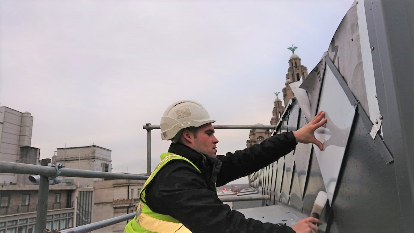 Cladding using shingles design on a commerical building on liverpool docks. Specialised metal roofing and cladding. 