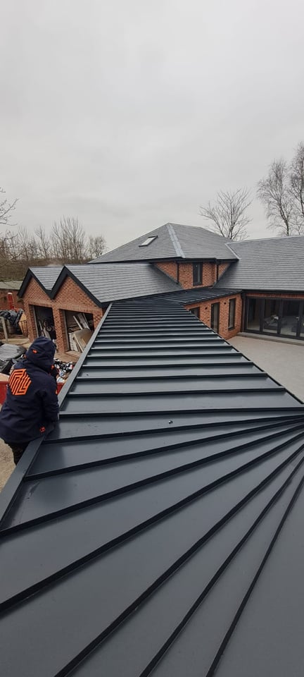 Link building baton role detail complete with matching steel Rainwater systems by roofing and cladding specialists. 